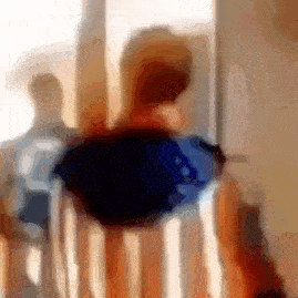 a blurry picture of a person sitting on a chair .