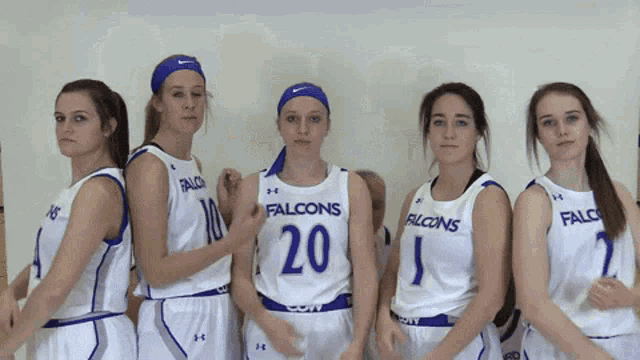 a group of female falcons basketball players pose for a photo