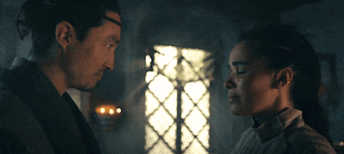 a man and a woman are looking at each other