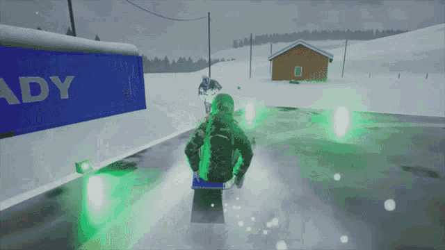 a person is riding a sled in front of a blue container that says ady