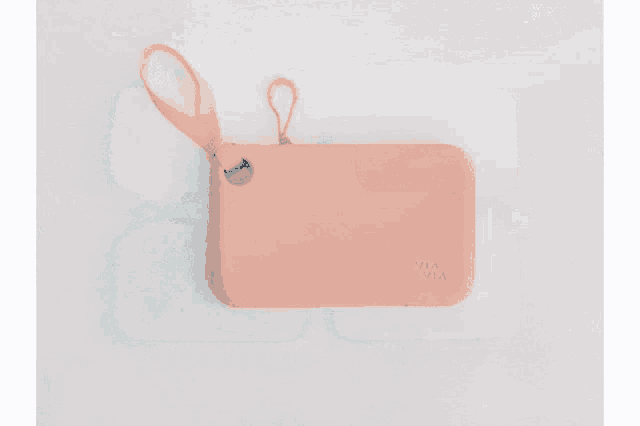 a person is holding a gray wallet that says mia mia