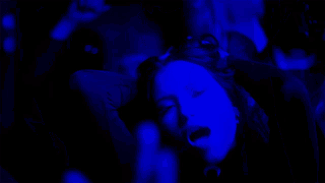 a woman with her mouth open is being held by a man
