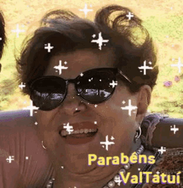 an older woman wearing sunglasses and a pearl necklace is smiling and surrounded by stars .