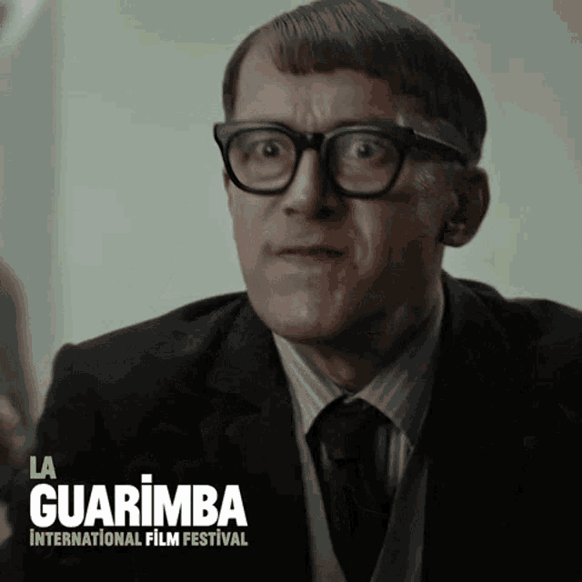 a man wearing glasses and a suit is featured in a poster for the la guarimba international film festival