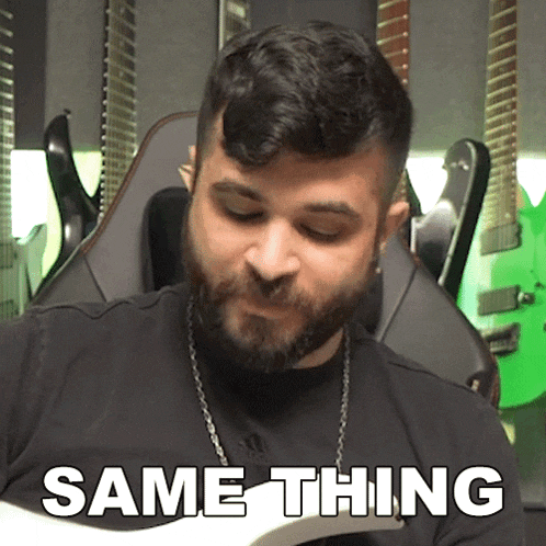 a man with a beard is holding a guitar and the word same thing is on the screen