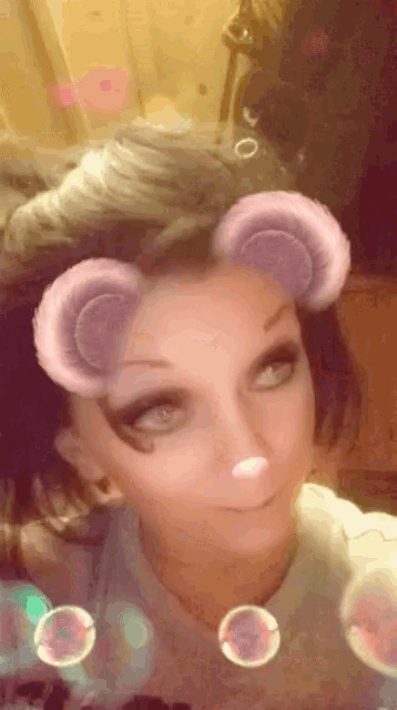 a woman is wearing a snapchat filter that looks like a cat