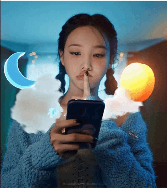 a woman in a blue sweater is using her phone