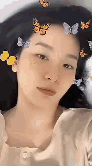 a close up of a woman 's face with butterflies on her face .