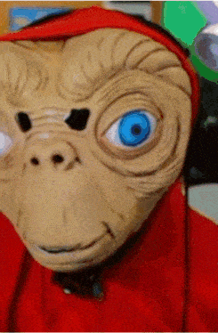 a close up of a person wearing a mask with blue eyes