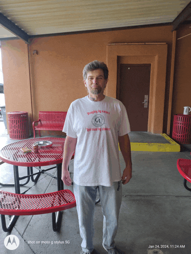 a man wearing a t-shirt that says " people by nature "