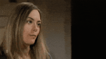 a close up of a woman 's face with a blurred background .