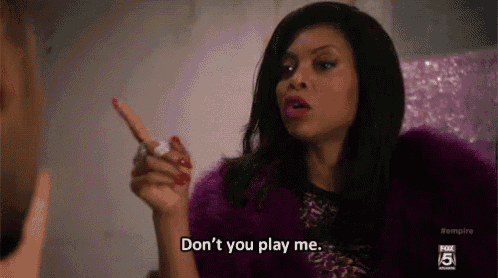 a woman in a purple fur coat is pointing at a man and saying `` do n't you play me . ''