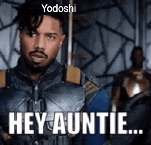a man in a superhero costume is saying `` hey auntie '' while holding a sword .