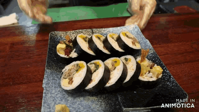 a plate of sushi with the words made in animatica on the bottom