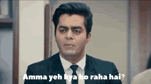 a man in a suit and tie says amma yeh kya ho raha hai .