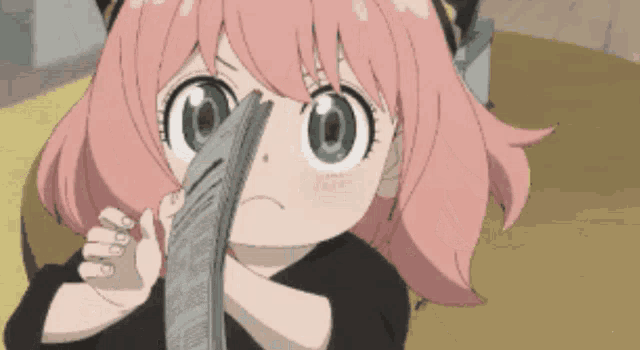 a little girl with pink hair is holding a newspaper in her hand .