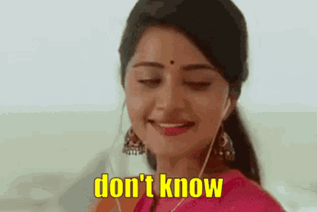 a woman wearing headphones is smiling and says " don 't know " .