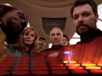 a group of people standing next to each other with a glowing t in the background
