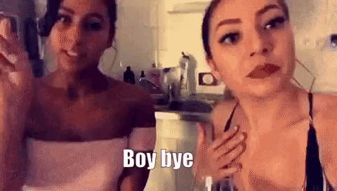 two women are standing next to each other and one of them is holding a glass of wine .