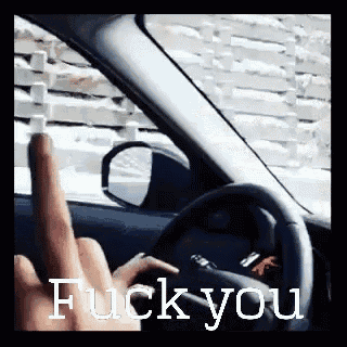 a person is driving a car and giving the middle finger with the words fuck you below it