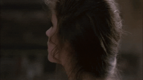 a close up of a woman 's face with a serious look on her face in a movie .
