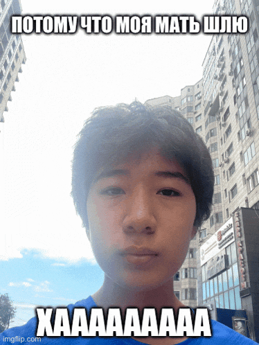 a young man with a blue shirt is standing in front of a building with a caption that says xaaaaaa
