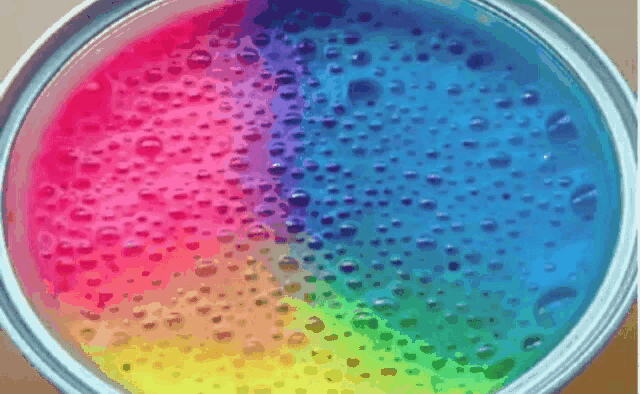 a close up of a colorful liquid with bubbles
