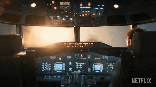 a man sits in a cockpit of an airplane with a netflix logo in the corner