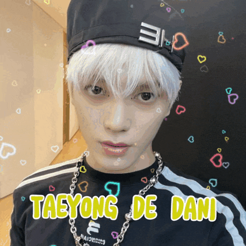 a man with white hair and the name taeyong de dani on the bottom