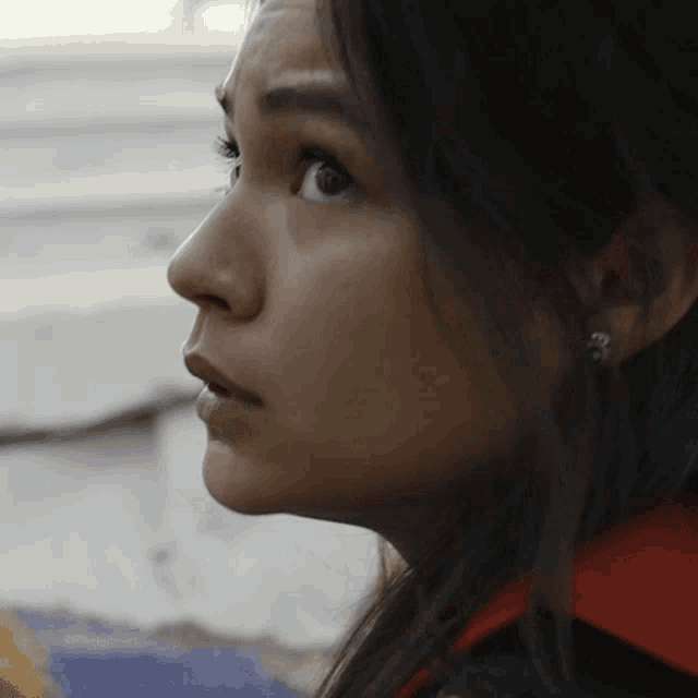 a close up of a woman 's face with a surprised expression