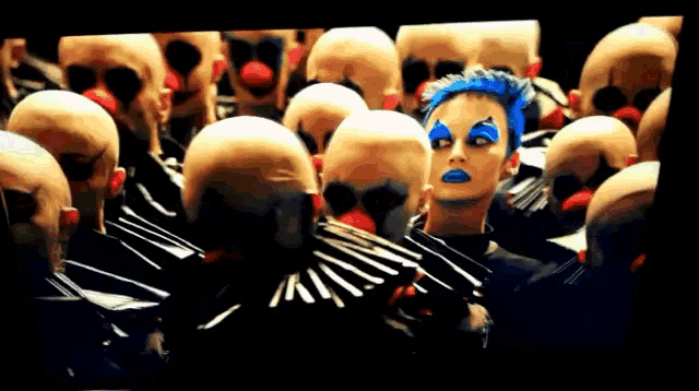 a clown with blue hair and red noses is surrounded by bald clown heads