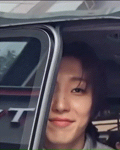 a close up of a person 's face in a car with the letter t on the side