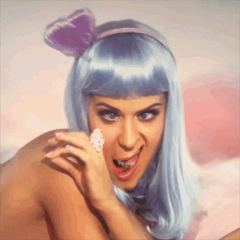 a woman wearing a blue wig and a purple bow on her head