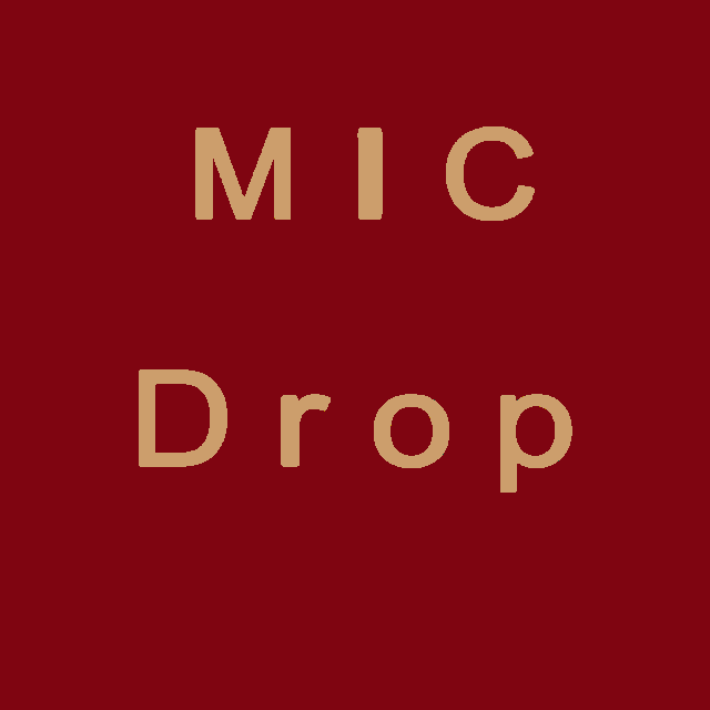 a microphone with the letter d on it stands in front of a red background
