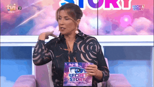 a woman is holding a secret story book