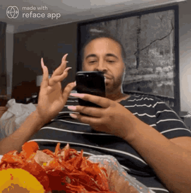 a man is looking at his phone while eating food