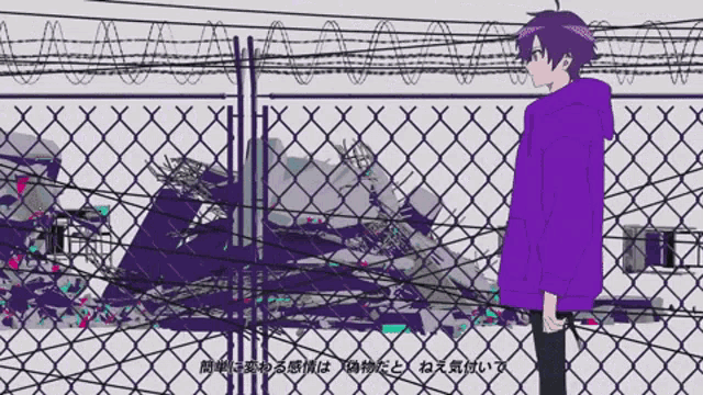 a man in a purple hoodie stands in front of a chain link fence