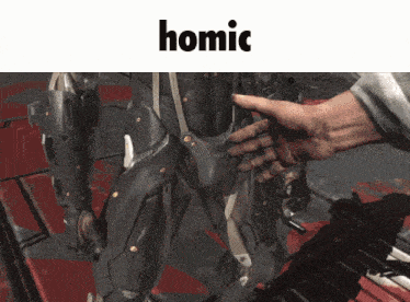 a video game character is being touched by a hand and the word homic is above it