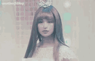 a woman in a white dress with a tiara on her head .