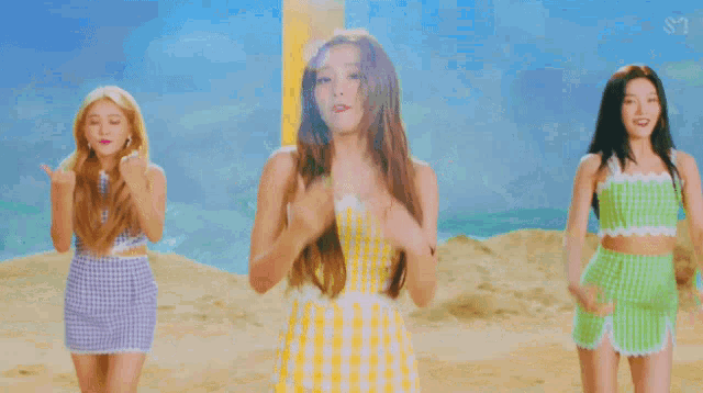a group of women are dancing on a beach with the letters s on the bottom