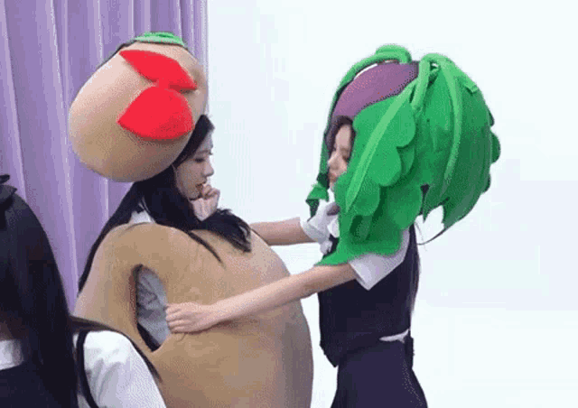 two women in costumes are hugging each other .