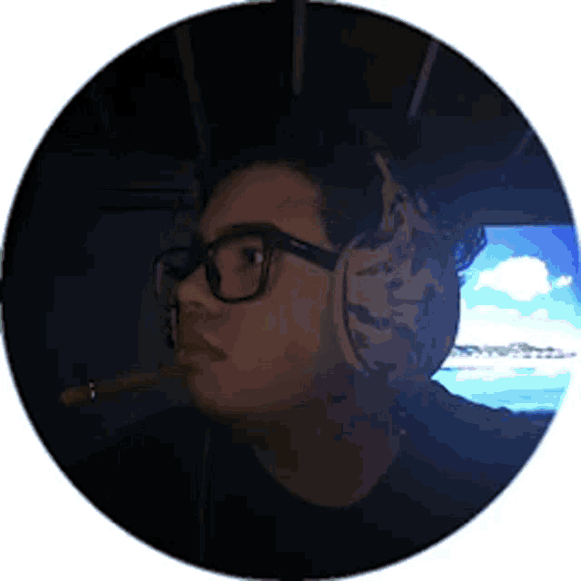 a man wearing glasses and headphones looks at a screen