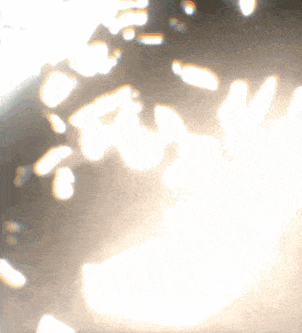 a blurred image of a light shining through a glass window