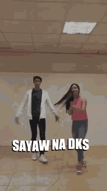 a man and a woman are holding hands and jumping in the air with the words sayaw na dks above them