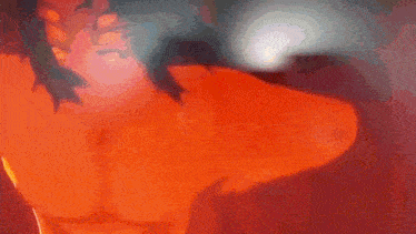 a blurred image of a person standing in front of a flame