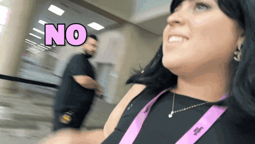 a woman with a lanyard around her neck that says ' no ' on it