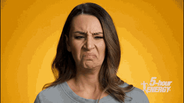 a woman is making a funny face in front of a yellow background that says 5 hour energy
