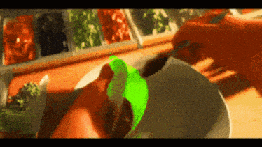 a green item is being poured into a white bowl