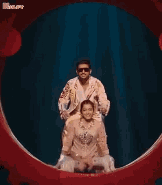 a man is riding on the back of a woman in a circle on a stage .