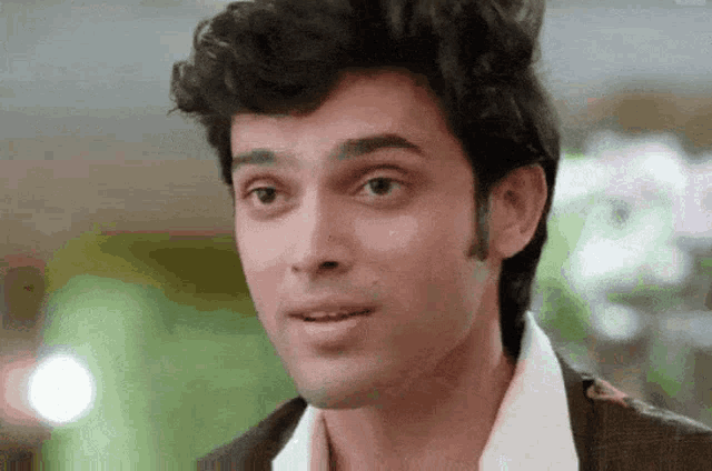 a close up of a man 's face with a serious look on his face